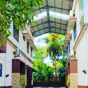 a building with a palm tree in a courtyard at His grace villas in Kottakkal