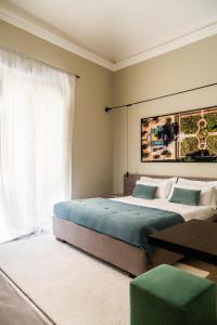 a bedroom with two beds and a large window at InCanto in Palermo