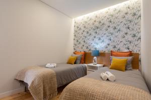 a bedroom with two beds and a wall mural at Host Wise - Enchanting Design Flat - Premium Location in Porto