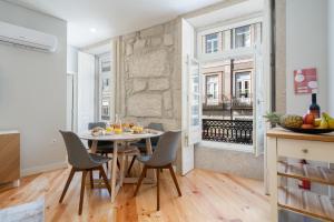 a kitchen and dining room with a table and chairs at Host Wise - Enchanting Design Flat - Premium Location in Porto