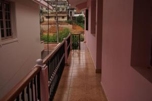 a hallway with a balcony with a view of a building at BREEZ VILLA in Madikeri