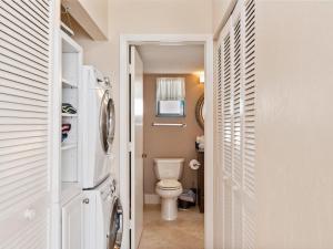a small bathroom with a toilet in a room at Knot a Care Remodeled Direct water access condo with ocean and pool views NOW SLEEPS SIX in Marco Island