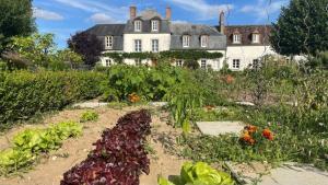 a garden of vegetables in front of a house at Domaine de Bel Ebat in Paucourt