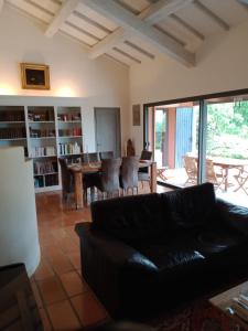 a living room with a couch and a table and chairs at les Bartavelles in Roussillon