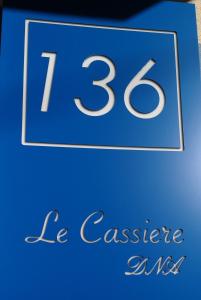 a blue sign with the number be cashier at Le Cassiere DNA in Roccalumera