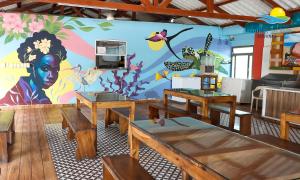 uma sala de jantar com um mural na parede em Arenillas del Mar em Tolú