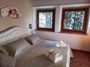 A bed or beds in a room at BELLA TUSCANY - Residence