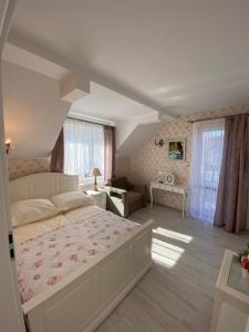 a bedroom with a large bed and a living room at Willa Pan Tadeusz in Łeba