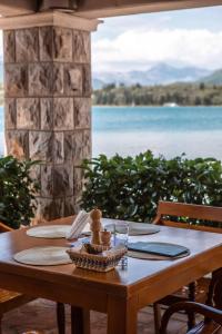 a wooden table with a view of the water at Apart-hotel Villa Lav in Tivat