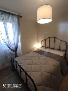 a bedroom with a large bed and a window at LA CASITA in Orvieto