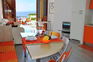 a kitchen with a table with a bowl of fruit on it at Villa Arborea vista mare in Sperlonga