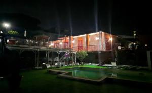 une maison avec une piscine dans la cour la nuit dans l'établissement B&B Iolì Vesuvio, à Ercolano