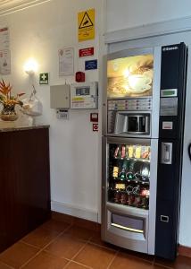 a refrigerator with its door open in a kitchen at O Cantinho in Benavente