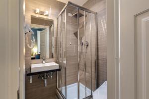 a bathroom with a shower and a sink and a mirror at Residenza Belli Inn in Rome