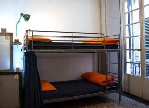 a bunk bed in a room with orange pillows at OStellin Genova Hostel in Genoa