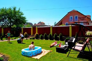 a group of people playing in a yard at Vila Deluxe - Liptov, Bešeňová in Bešeňová