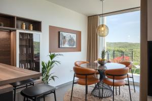 a kitchen and dining room with a table and chairs at Royal Hilltop Residence in Labin