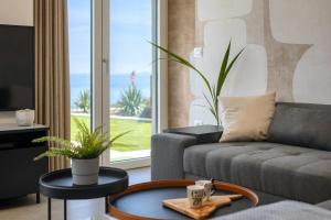 a living room with a couch and a table at Royal Hilltop Residence in Labin