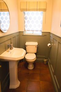 a bathroom with a toilet and a sink at Ballyheifer House - a beautiful 5 bedroom home. in Magherafelt
