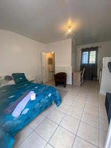 a bedroom with a bed and a tiled floor at Charming 1-Bed Apartment 20 mins to Paris by train in Goussainville +13 photos
