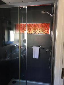 a bathroom with a shower with a glass door at Bosanneth in Falmouth