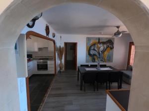 a kitchen and a dining room with a table in a room at Son Riera Petit Paradís in Banyalbufar