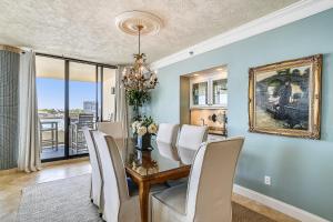 a dining room with a table and white chairs at East Pass Towers 304 Condo in Destin