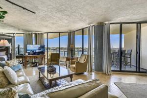 a living room with a couch and a table with a tv at East Pass Towers 304 Condo in Destin