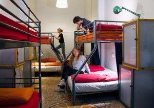 two people in a bunk bed in a room at OStellin Genova Hostel in Genoa