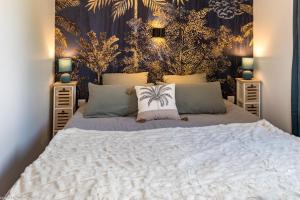 a bedroom with a large bed with two night stands at Les Gîtes du Griffon l'Erable in Aubigny-lès-Sombernon