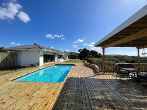 a wooden deck with a swimming pool on a house at Gypsea Daze in Pennington