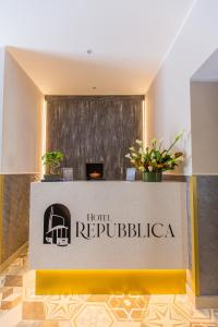 a sign for the hotel repubblica in a lobby at Hotel Repubblica in Milan