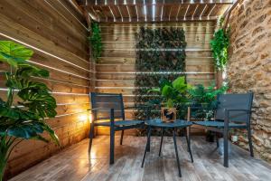 a table and chairs in a room with plants at Suite SPAtio - Jacuzzi Privé - 20min Disneyland PARIS in Pézarches