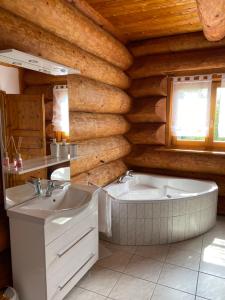 a bathroom with a tub and a sink at Traumhaftes Blockhaus am Rhein in Kamp-Bornhofen