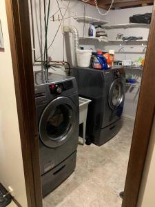 a washing machine and a washer in a kitchen at Main Floor Bright & Spacious Apartment in Lethbridge