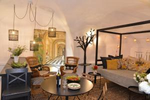 a living room with a couch and a table at La BARBELLA in Lourmarin