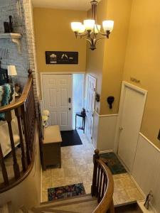 a hallway with a staircase leading to a house at Main Floor Bright & Spacious Apartment in Lethbridge +50 photos