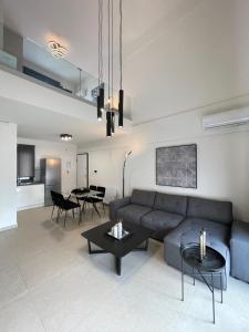 a living room with a couch and a table at Athenean Modern Escape near Marina Flisvos in Athens