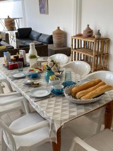a table with a plate of bread on it at Dulaa Deema Residence Brufut Heights in Trankill