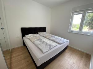 Posteľ alebo postele v izbe v ubytovaní Apartman Emanuel
