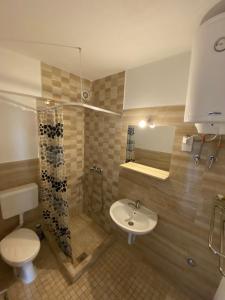a bathroom with a toilet and a sink and a shower at Apartmani Milka S in Bar