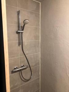 a shower with a shower head in a bathroom at Danhostel Sønderborg City in Sønderborg