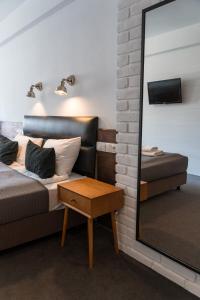 a bedroom with a mirror and a bed and a table at Trybunalska in Lublin