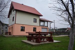 a picnic table in front of a building at Deluxe Studio & Rooms Zarubica in Žabljak