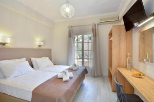 a hotel room with a bed with towels on it at Dimitris Residence 1 in Kalami