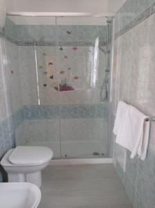 a bathroom with a shower with a toilet and a sink at Spiaggia LazzarettoHouse in Alghero