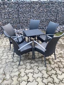 a group of chairs and tables on a patio at Fressh House in Sîncrăieni