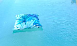 a blue object is floating in the water at Hotel Baglio Di Scopello in Scopello
