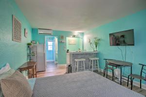 a bedroom with a bed and a kitchen with a bar at Tropical Pass-A-Grille Gem with Direct Beach Access! in St Pete Beach