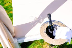 a bottle of wine in a basket on a table at Hotel Baglio Di Scopello in Scopello